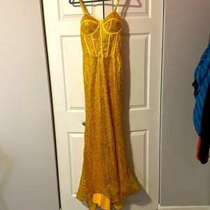 A gold prom dress, never worn in a size medium.